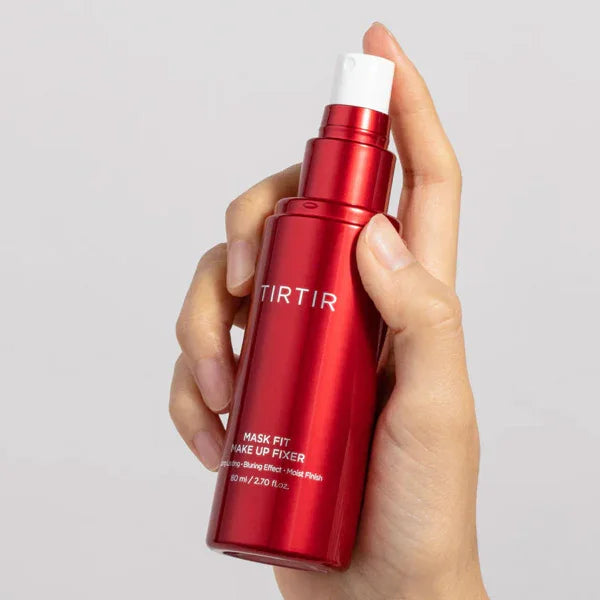 Hand holding TIRTIR Mask Fit Make Up Fixer red spray bottle, Korean makeup setting spray